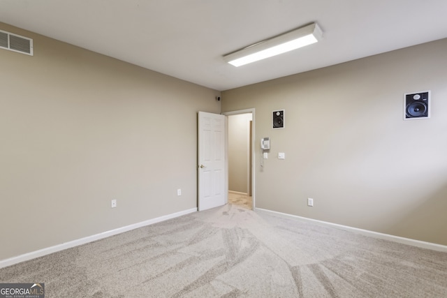 spare room with light colored carpet