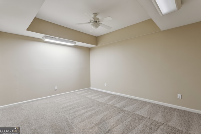 carpeted spare room featuring ceiling fan