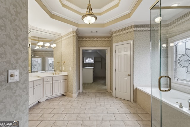 bathroom featuring crown molding, a relaxing tiled tub, vanity, a tray ceiling, and tile patterned floors