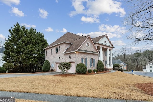 view of front of home with a garage and a front lawn