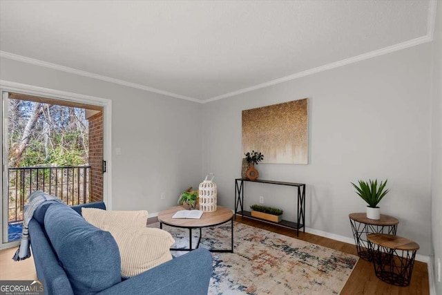 living room with wood-type flooring and ornamental molding