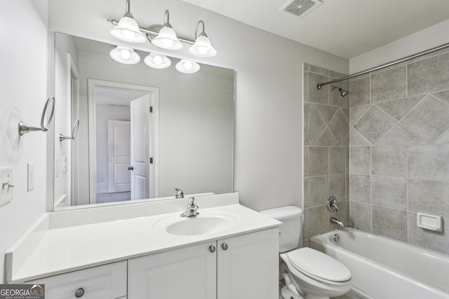 full bathroom featuring vanity, toilet, and tiled shower / bath combo