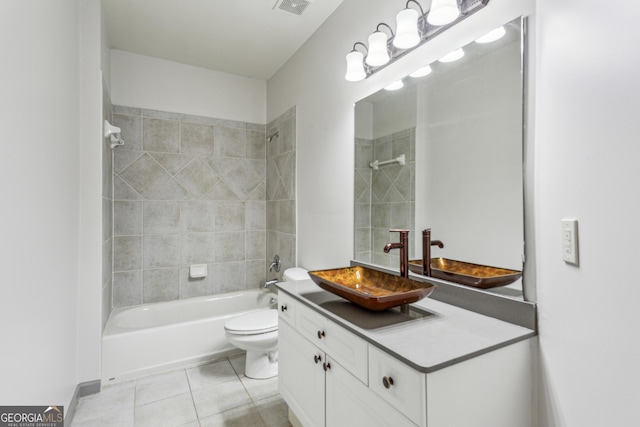 full bathroom featuring tiled shower / bath combo, vanity, tile patterned flooring, and toilet