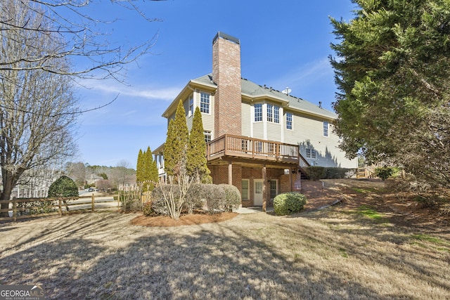 rear view of property featuring a wooden deck