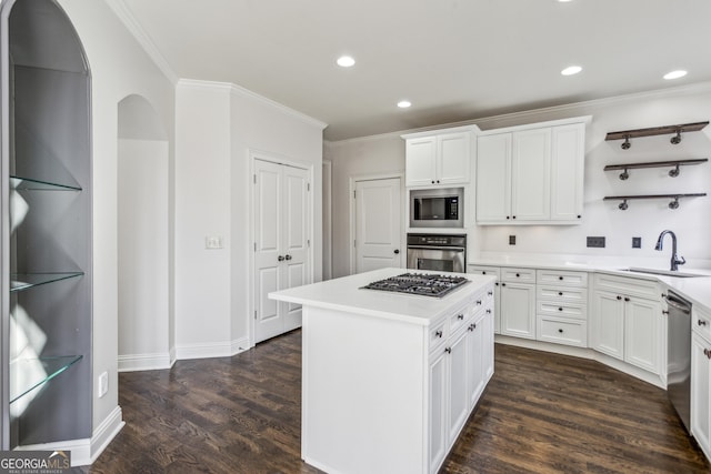 kitchen with a kitchen island, appliances with stainless steel finishes, dark hardwood / wood-style floors, white cabinetry, and sink