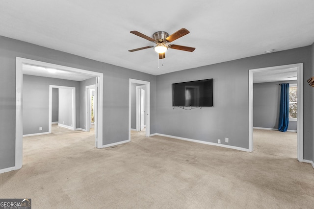 empty room with light colored carpet and ceiling fan