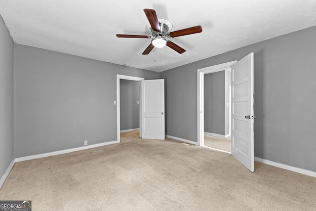 unfurnished bedroom with ceiling fan and light carpet