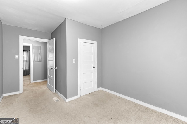 unfurnished bedroom featuring light colored carpet