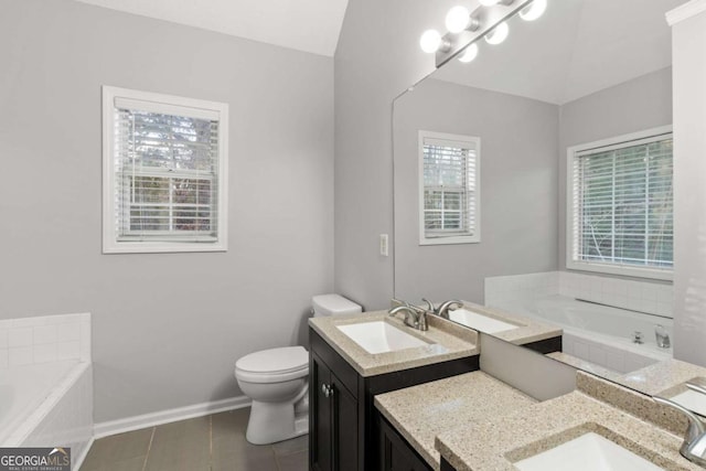 full bathroom with vanity, baseboards, tile patterned flooring, a garden tub, and toilet