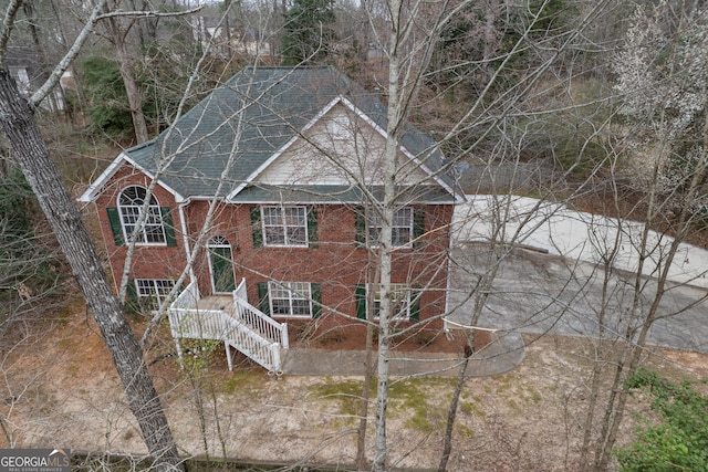 split foyer home with brick siding and roof with shingles