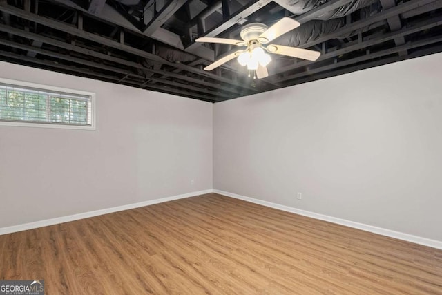 basement with ceiling fan, baseboards, and wood finished floors