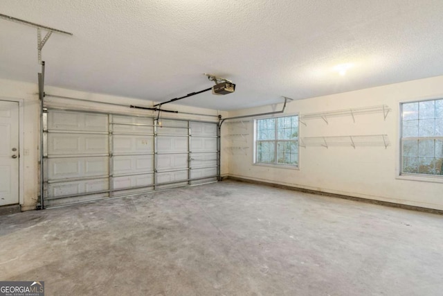 garage with a garage door opener and baseboards