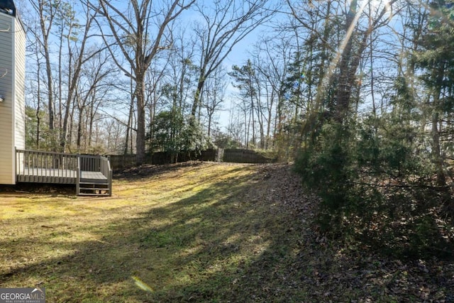 view of yard with a deck and fence