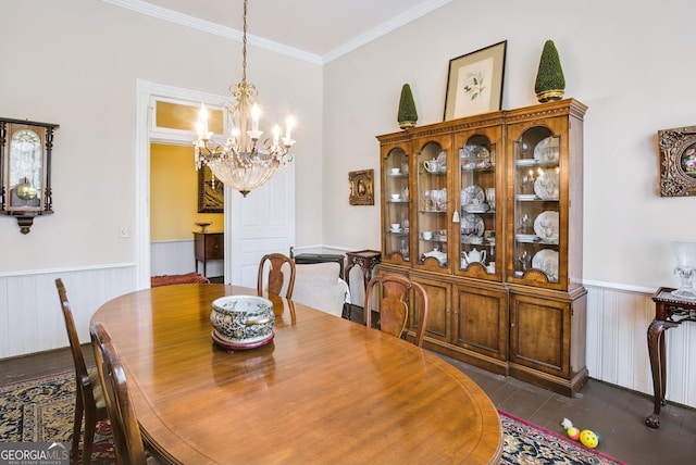 dining space with ornamental molding, a chandelier, and dark hardwood / wood-style flooring