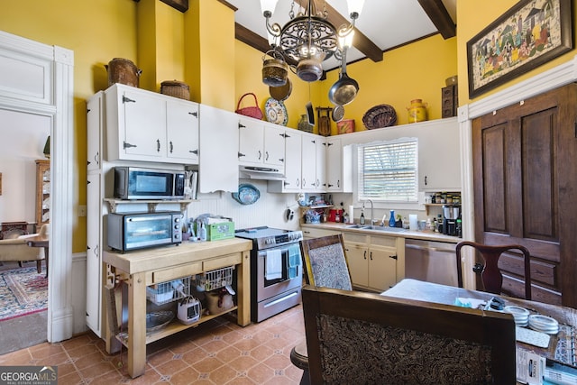 kitchen with sink, stainless steel appliances, a chandelier, white cabinets, and beamed ceiling