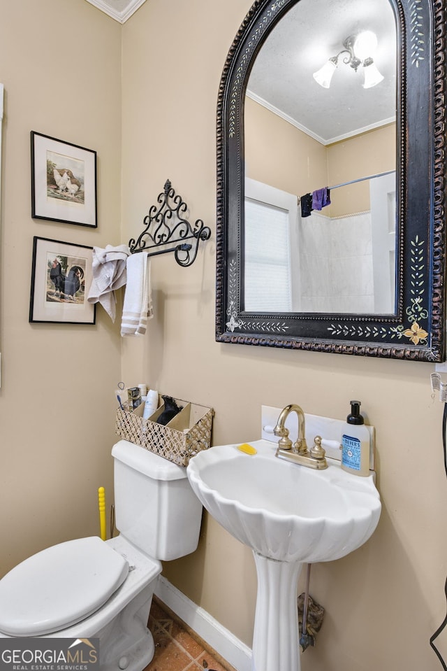 bathroom with ornamental molding and toilet