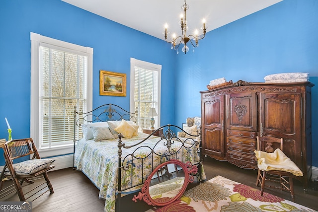 bedroom with dark wood-type flooring and a chandelier