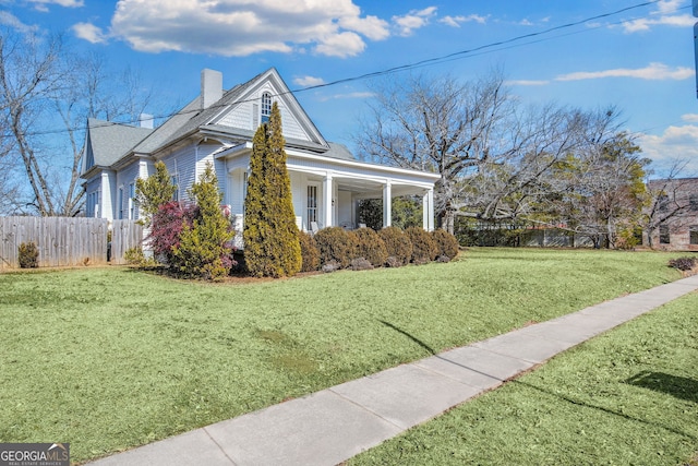 view of property exterior featuring a yard and a porch