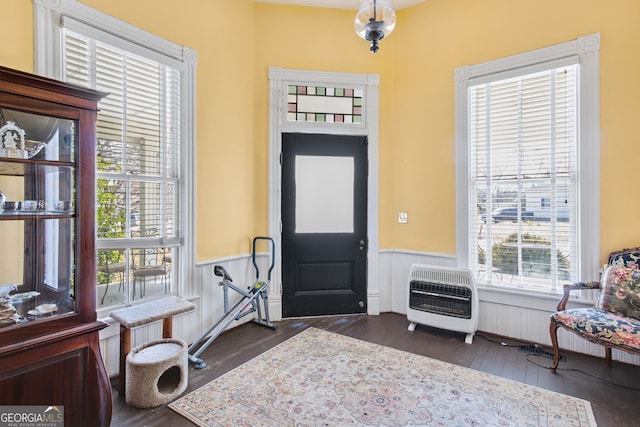 entryway with heating unit and dark hardwood / wood-style floors