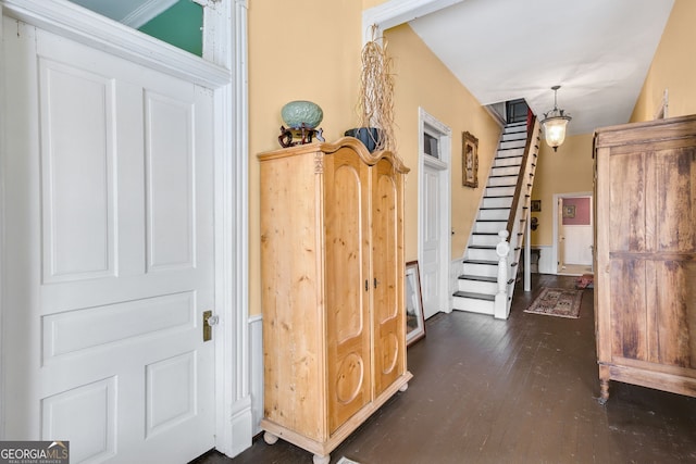 hallway with dark hardwood / wood-style flooring