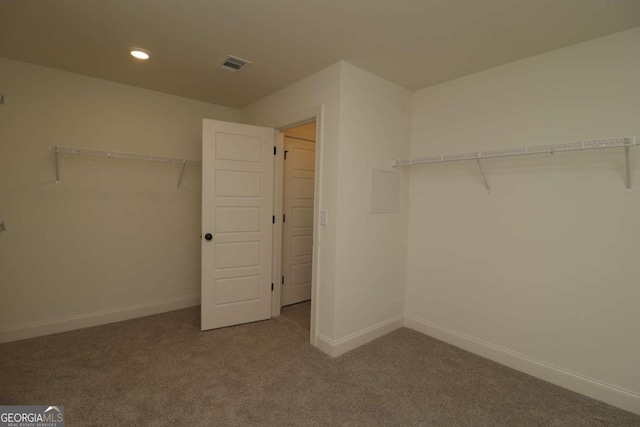 walk in closet with carpet