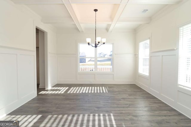 unfurnished dining area with a healthy amount of sunlight, a notable chandelier, coffered ceiling, and beamed ceiling