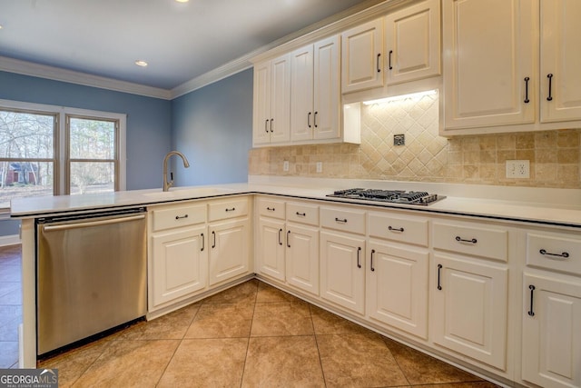 kitchen featuring sink, crown molding, tasteful backsplash, kitchen peninsula, and stainless steel appliances