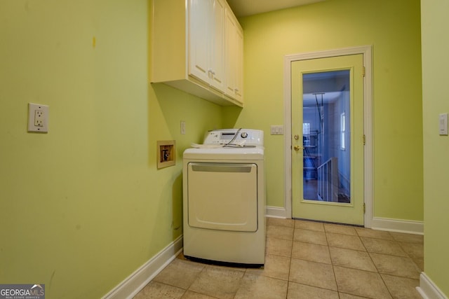 washroom with cabinets, washer / dryer, and light tile patterned floors