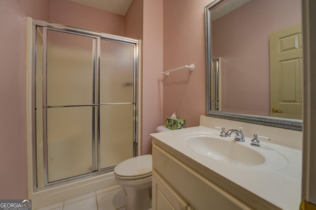 bathroom with vanity, tile patterned flooring, a shower with door, and toilet