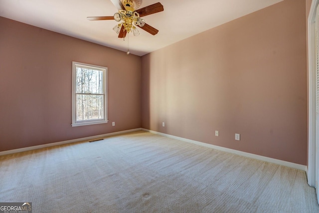 unfurnished room featuring light colored carpet and ceiling fan