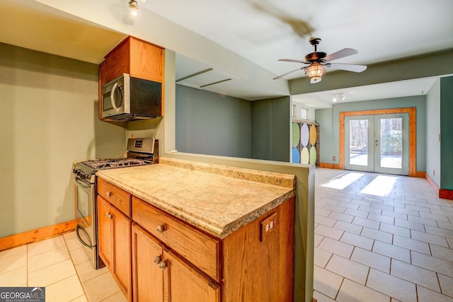 kitchen with french doors, ceiling fan, appliances with stainless steel finishes, and light tile patterned floors