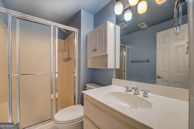 bathroom featuring vanity, toilet, and walk in shower