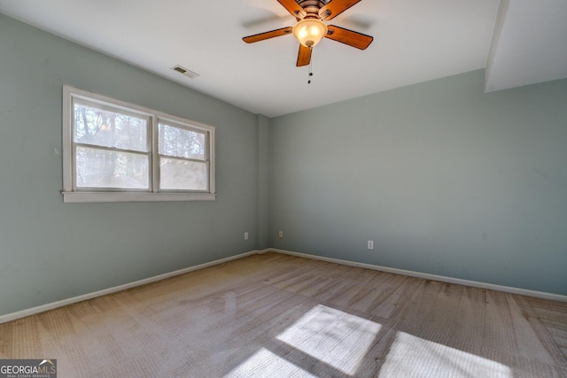 carpeted spare room with ceiling fan