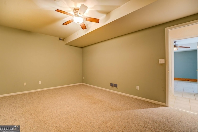 carpeted spare room with ceiling fan