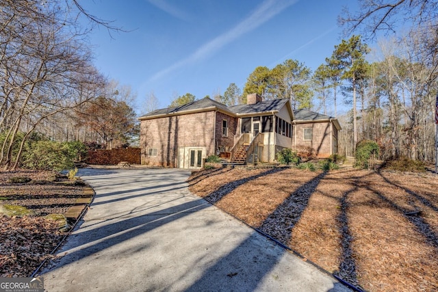 view of front of home featuring a sunroom and french doors