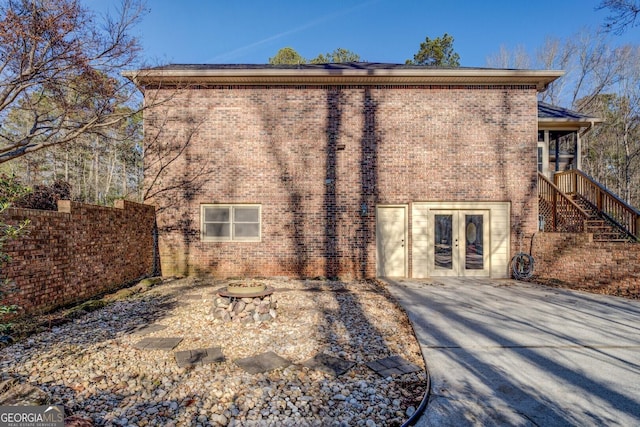 back of house with french doors and a fire pit