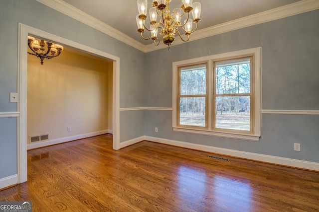 unfurnished room with a notable chandelier, crown molding, and wood-type flooring