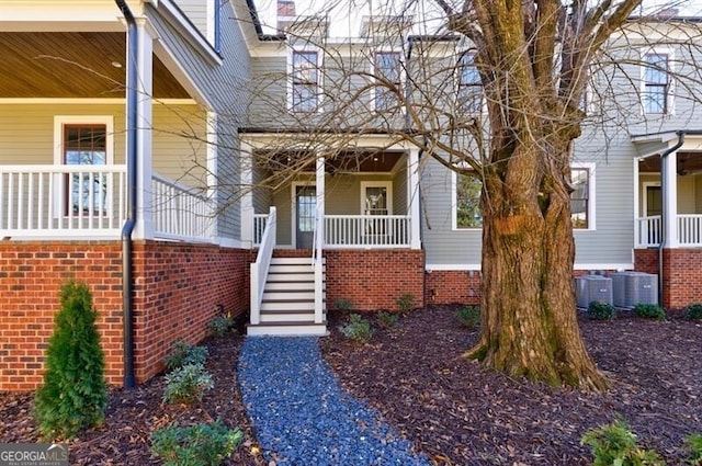 property entrance with covered porch and central air condition unit