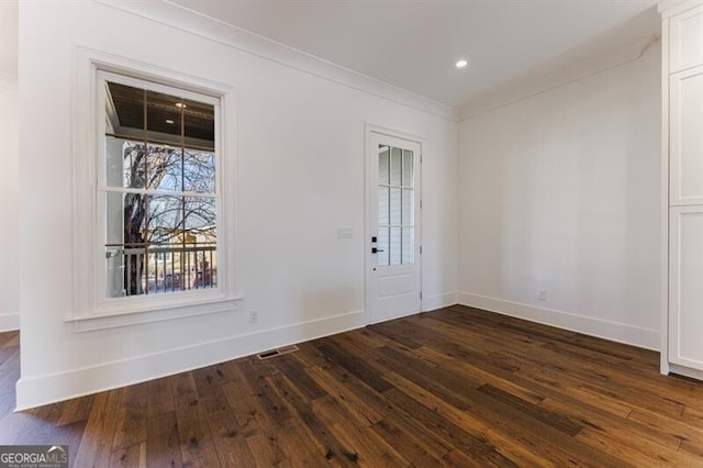 entrance foyer featuring ornamental molding and dark wood-type flooring