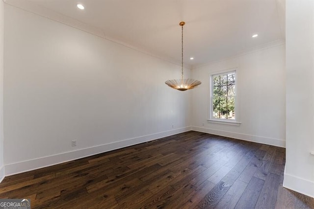 unfurnished room featuring dark wood-type flooring and ornamental molding