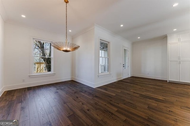 unfurnished dining area with ornamental molding and dark hardwood / wood-style floors