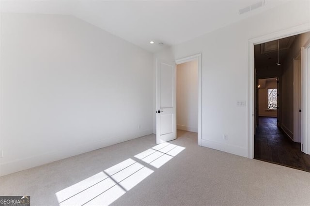 unfurnished bedroom with lofted ceiling and light carpet