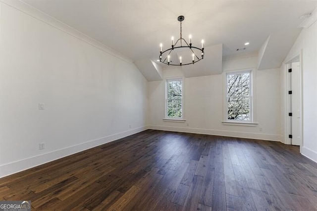 interior space featuring an inviting chandelier, ornamental molding, and dark hardwood / wood-style flooring