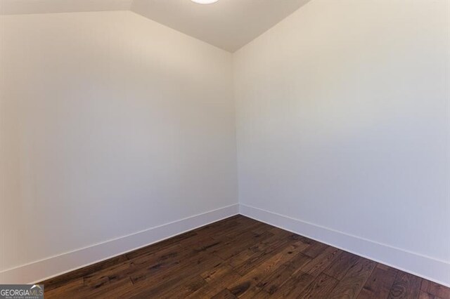 spare room with lofted ceiling and hardwood / wood-style floors