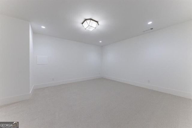 spare room featuring light colored carpet