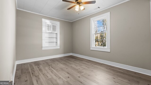 spare room featuring crown molding, ceiling fan, and light wood-type flooring