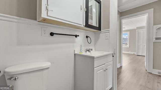 bathroom featuring vanity, toilet, and hardwood / wood-style floors