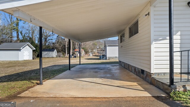 view of patio / terrace with a shed and a carport