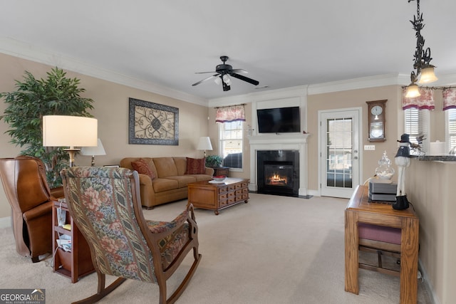 living room featuring light carpet, crown molding, a fireplace, and ceiling fan