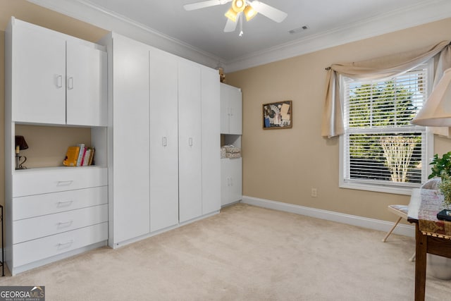 interior space featuring crown molding, light colored carpet, and ceiling fan